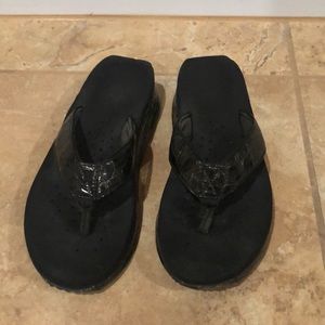 Volatile black flip flops
